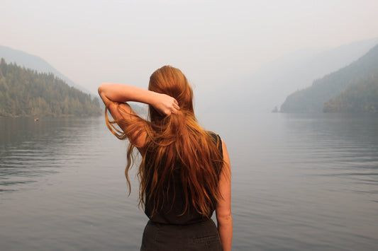 Brown hair human looking at lake